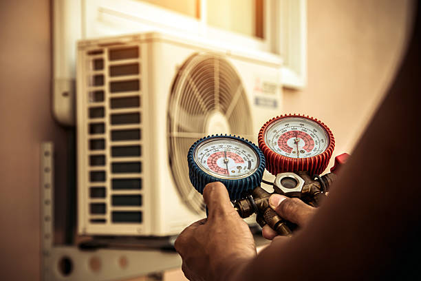 Professional Air Conditioning Service technician working in Warrensburg, MO
